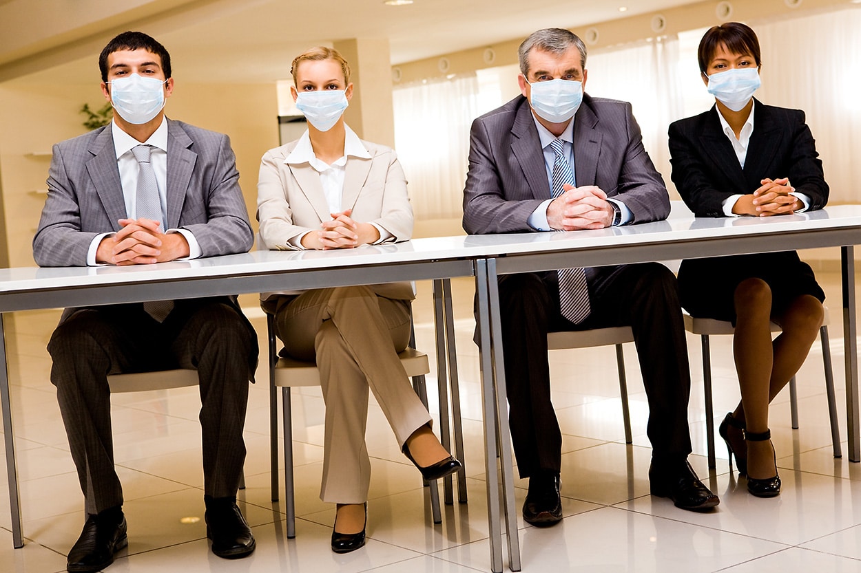 photo of people in business attire wearing medical masks